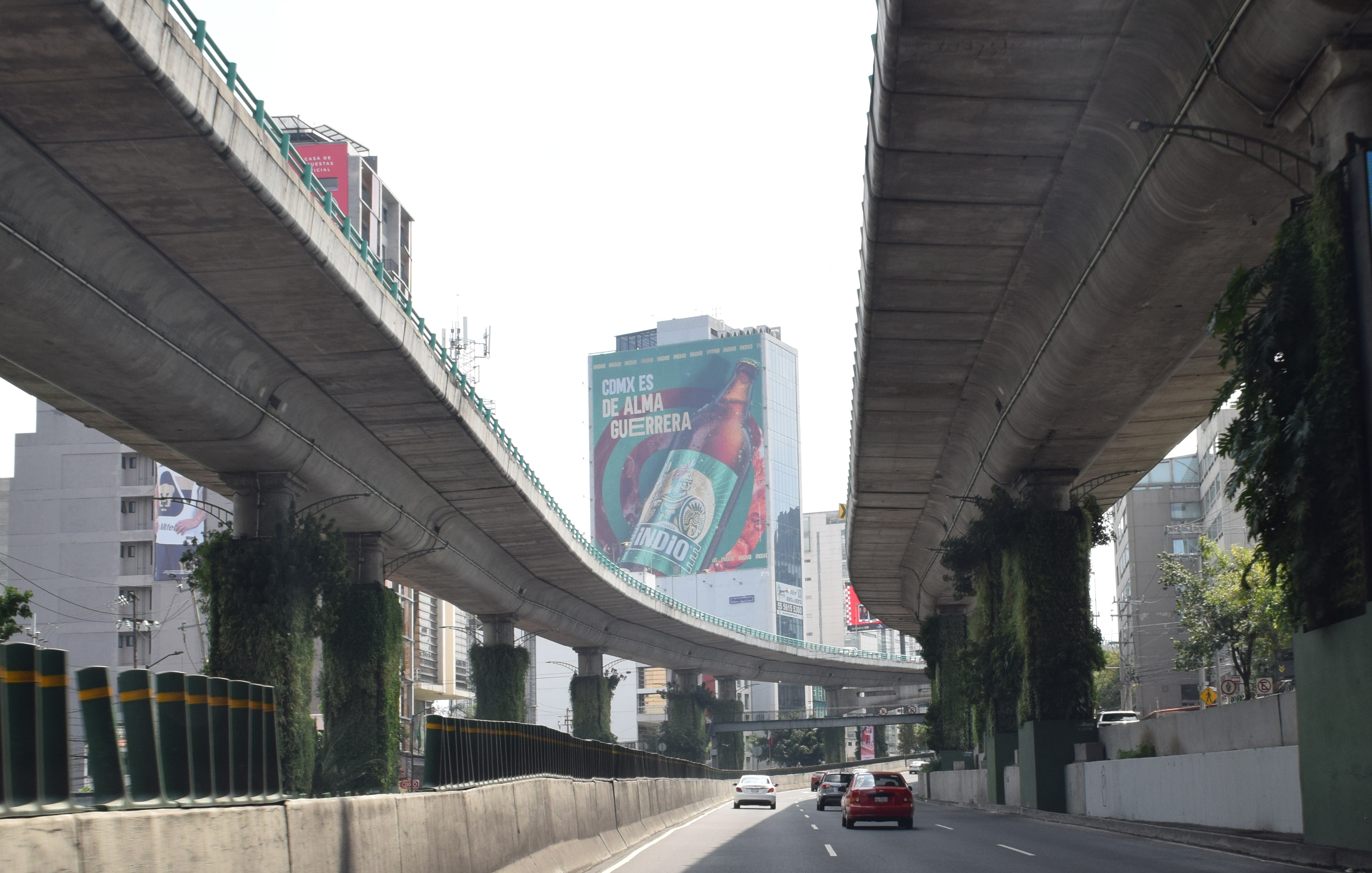 Cerveza Indio large-format advertising wall by BusBus, OOH outdoor advertising on a second-level highway in CDMX, Mexico